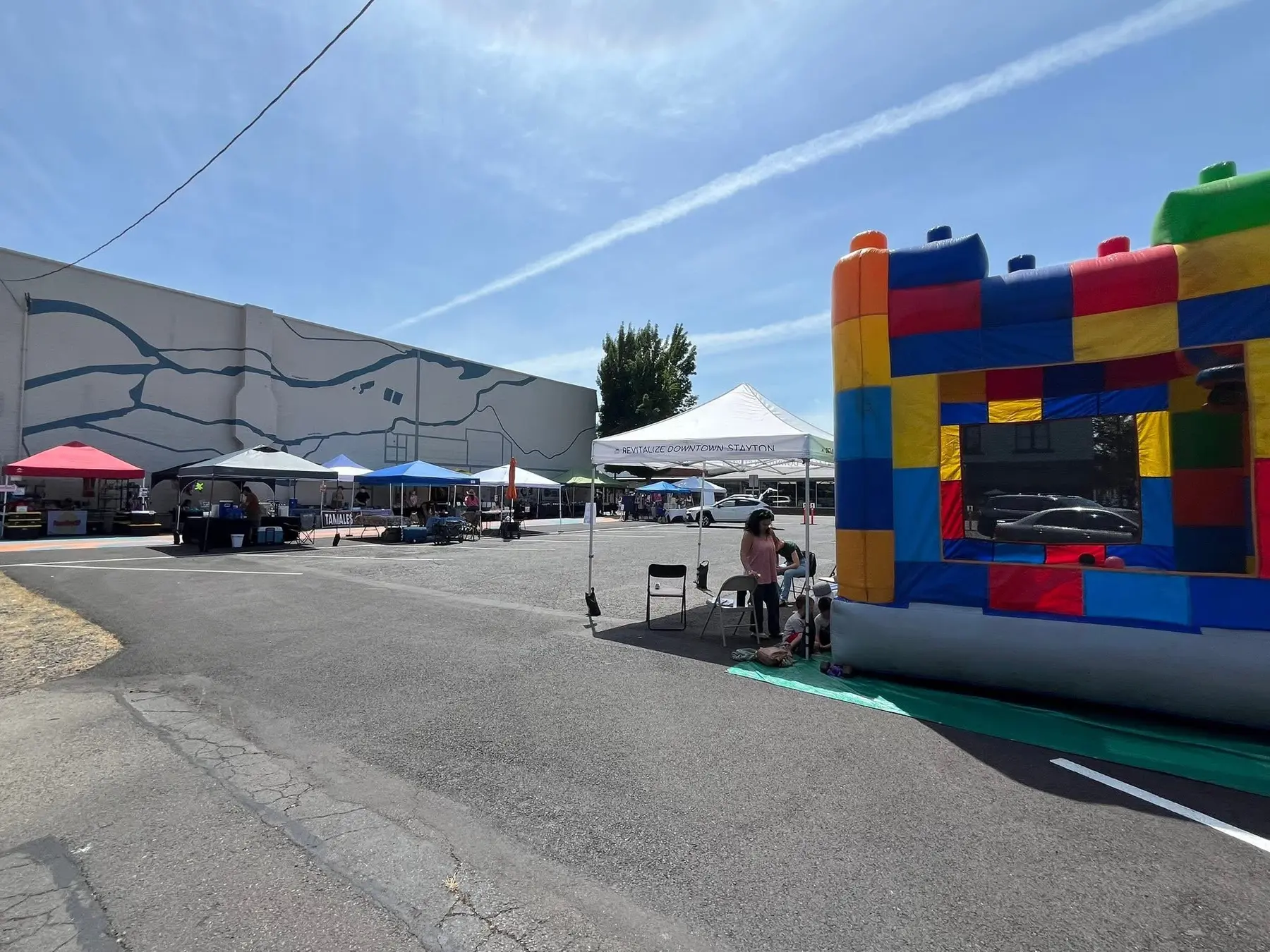 Vendor tents and a bounce house at the Stayton Farmers Market