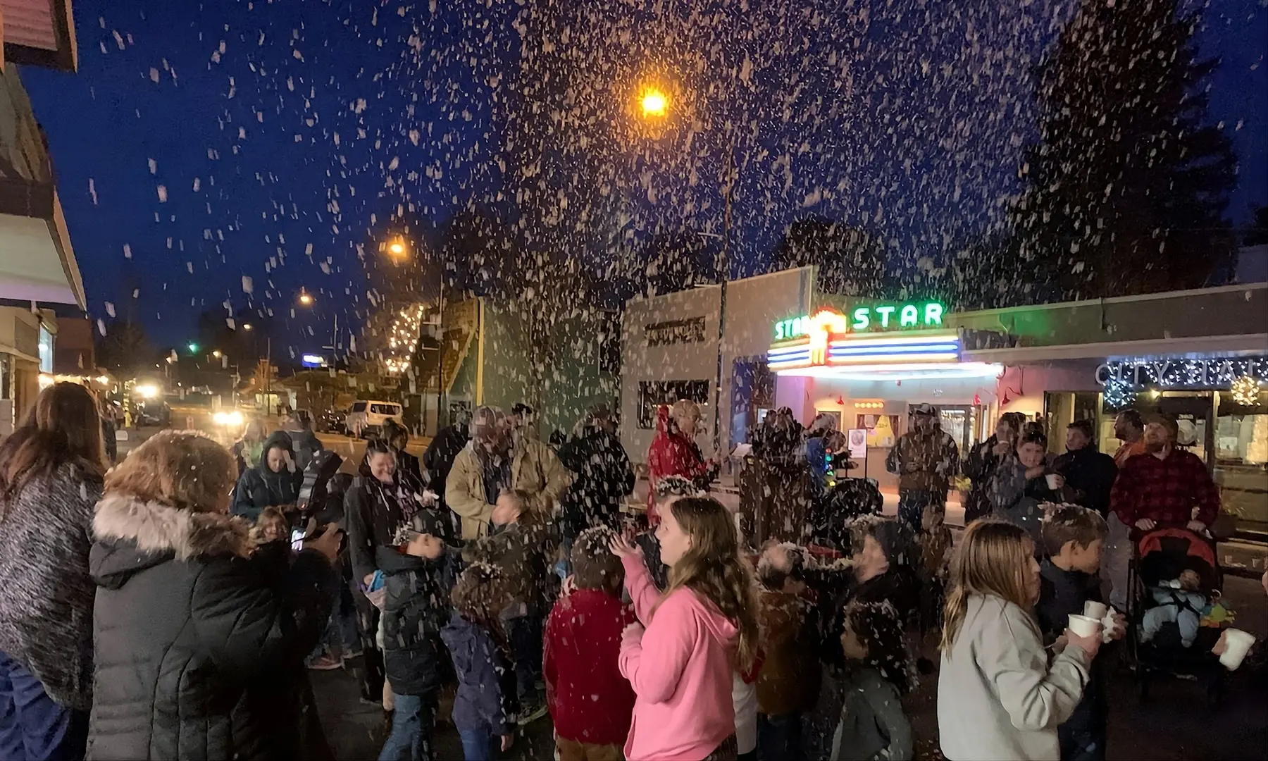A crowd in the snow at Holiday Fest