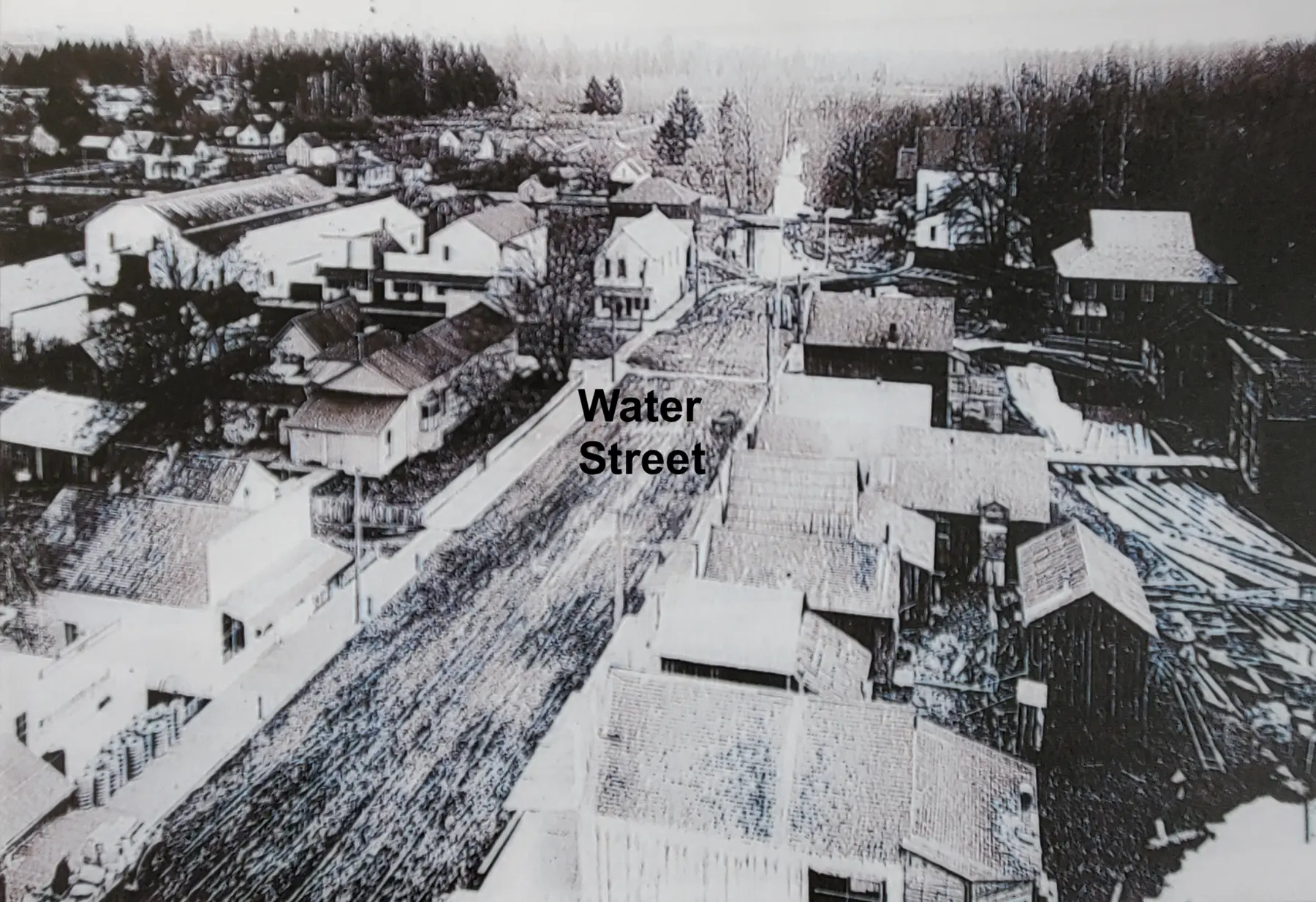 Brown lumber mill along the Stayton Ditch, where industry and town life began side by side.