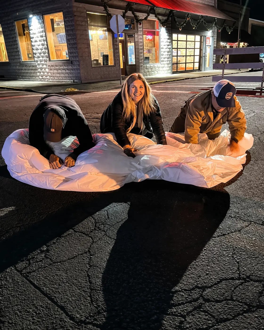Volunteers with a Holiday Fest igloo